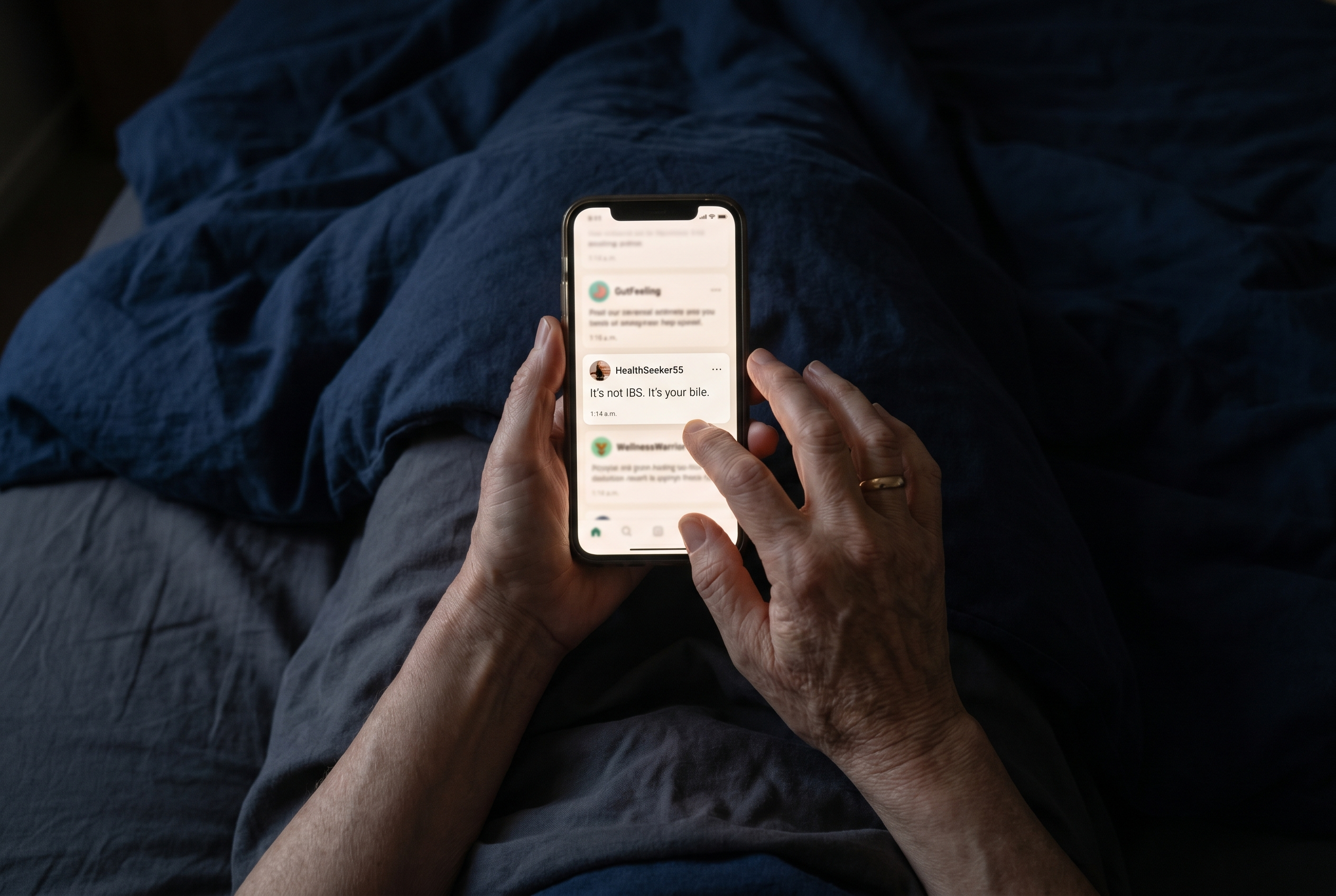 A phone screen glowing in a dark room, showing a forum post that reads: It's not IBS. It's your bile. Timestamp 1:14 a.m.